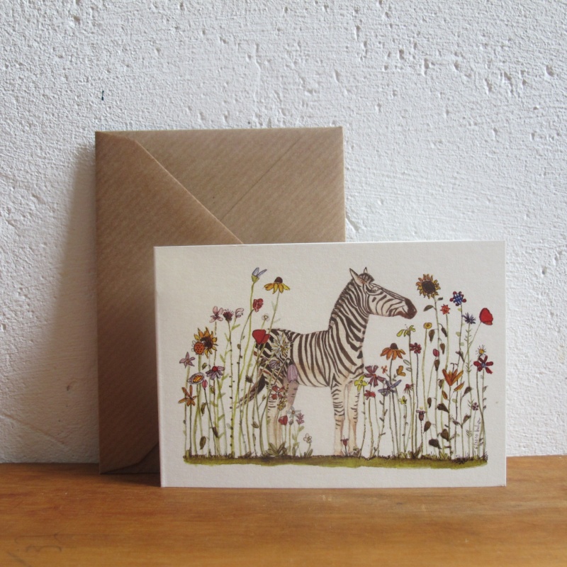 Zebra steht in einer sehr bunten Blumenwiese